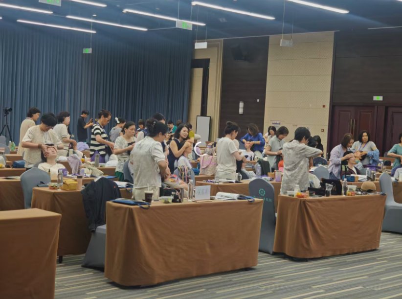 Wide view of the training hall during a practice session with students at tables